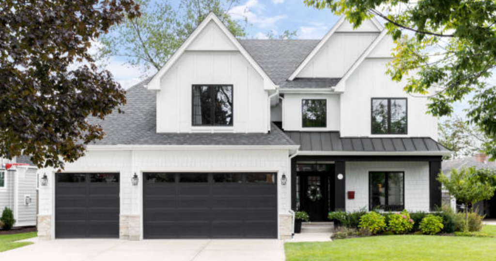 white house with black garage doors